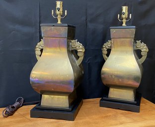 A Vintage Pair Of Brass Lamps With Elephant Handle Details