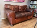 A Comfy And Lived In Leather Loveseat By Robinson & Robinson