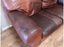 A Comfy And Lived In Leather Loveseat By Robinson & Robinson