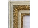 White And Gold Frame With Leaf Motif Within The Gold