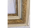 White And Gold Frame With Leaf Motif Within The Gold
