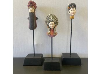 A Group Of  Three Hand Painted Cast Resin Heads  On Wooden Stand  Made In Philippines