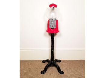 A Gumball Machine On Cast Iron Stand