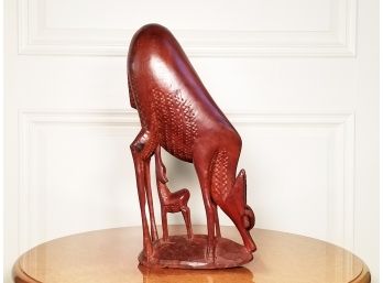 A Carved Hardwood Sculpture Depicting A Mother And Baby Deer