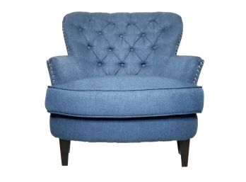 An Upholstered Arm Chair With Nailhead Trim