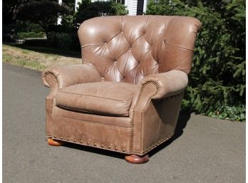A Tufted Leather Arm Chair With Nailhead Trim