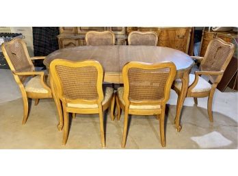 Dining Table With Six Cane Back Chairs And Several Extension Leaves