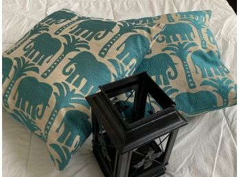 Decorative Throw Pillows And A Candle Holder