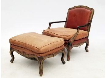 A Leather Upholstered Bergere Chair And Ottoman