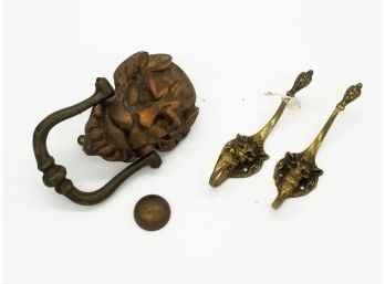 An Antique Brass Lion's Head Door Knocker And Two Lion's Head Hooks