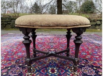 Antique Upholstered Ottoman With Fluted Legs And Trestle Base