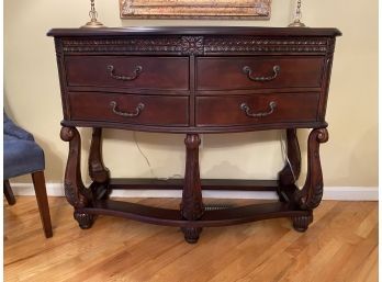 Old English Inspired Console Cabinet With Carved Details And Trestle Base