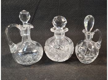 Three Assorted Vintage Crystal Cruets Each With Stoppers