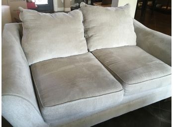 Two Cushion Tan Love Seat Upholstered With Extra Throw Pillows
