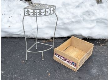A Vintage Fruit Crate And Wrought Iron Plant Stand