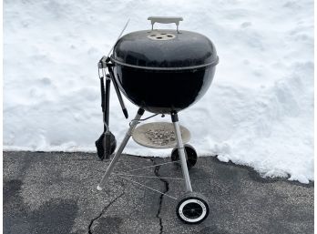 A Weber Charcoal Grill And Accessories