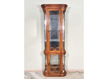 A Hardwood And Glass Mirror Backed Curio Cabinet
