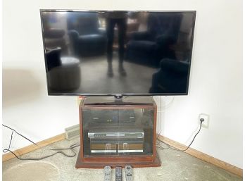 A Samsung 48' Flat Screen TV, Stand, And Accessories