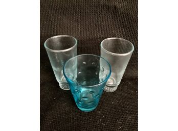 Two Small Skinny Pale Blue Glasses And One Bright Teal Cup