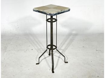 A Vintage Metal Plant Stand With Tile Top