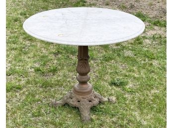 A Vintage Marble Top Tilt Top Table On Cast Iron Base