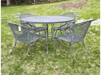 A Vintage Wrought Iron And Mesh Dining Table And Set Of 4 Chairs