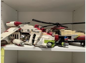 4 Shelves Of Assorted Legos 3 Large Cars And 2 Aircract & Miscellaneous