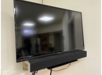 Insignia 41' TV In The Gym Basement With Vizio Soundbar And Sony TV Stand
