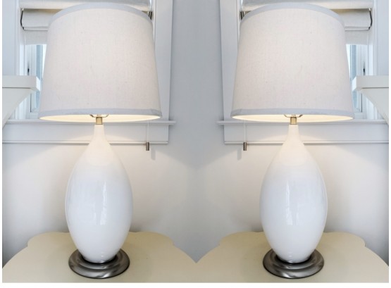 Pair Of White Ceramic Lamps With A Brushed Chrome Base And Linen Shade