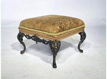 A Vintage Footstool With Wrought Iron Base
