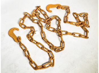 A Vintage Industrial Orange Tow Chain And Hooks