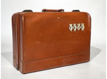 A Vintage Leather Suitcase With Yale Insignia