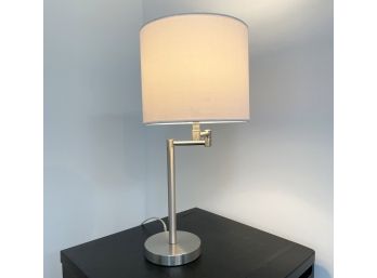 A Modern Brushed Steel Stick Lamp With Articulating Arm