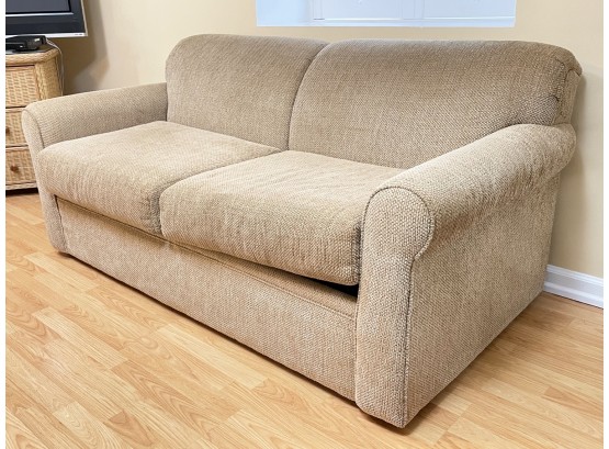 A Sleeper Sofa In Neutral Upholstery