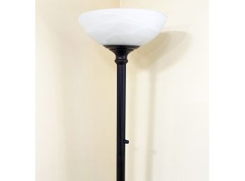 A Torchiere Lamp With Bronze Tone Fittings