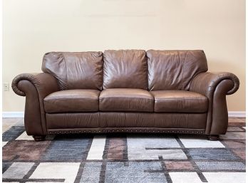A Chestnut Leather Sofa By Natuzzi