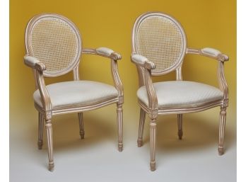 Pair Of Louis XVI Inspired Cane Back Arm Chairs With A Pickled White Wash Finish