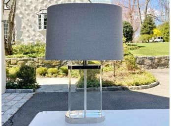 Clear Lucite Lamp With Chrome Accents And Neutral Fabric Shade