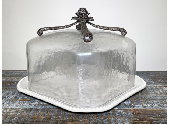 A Ceramic Cake Dish With Glass Lid