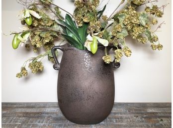 A Ceramic Urn With Faux Floral