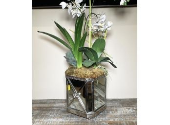 A Mirrored Cache Pot With Faux Orchid