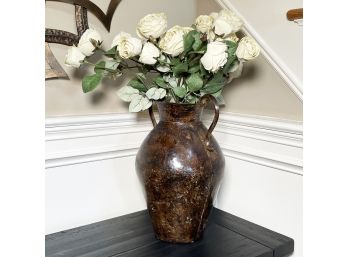 A Large Ceramic Urn With Faux Floral