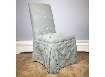 A Slip Covered And Skirted Banquet Chair