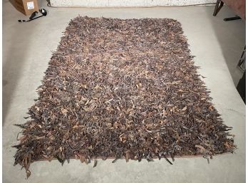 A Leather Rag Rug In Rust Tones