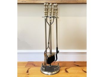 A Pair Of Fireplace Tools In Antique Brass Finish