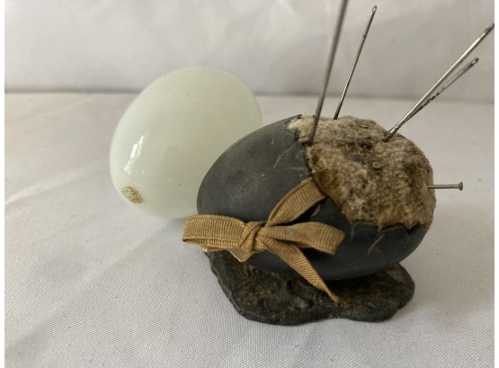 Heavy Metal Egg Used As A Pin Cushion And A White Hollow Glass Egg