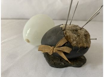 Heavy Metal Egg Used As A Pin Cushion And A White Hollow Glass Egg