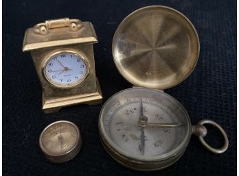 A Clock And Two Old Compasses