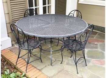 A Wrought Iron Table And Chair Set