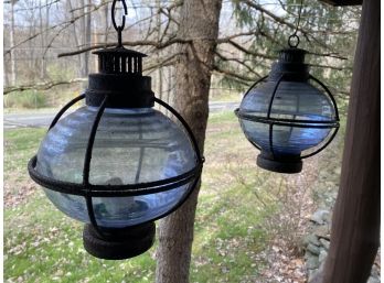 A Pair Of Hanging Blue Glass Outdoor Candle Lanterns